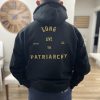 Man wearing black “Long Live the Patriarchy” hoodie with Patrios logo on front and bold statement on back, symbolizing masculine strength and tradition.
